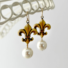 Load image into Gallery viewer, Antique bronze toned fleur-de-lis earrings with pearl drops on a white background
