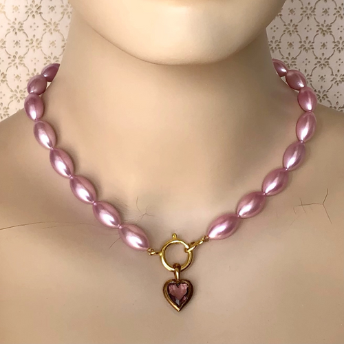 necklace of vintage rice-shaped pearlised beads in soft amethyst pink with vintage amethyst heart pendant displayed on a mannequin