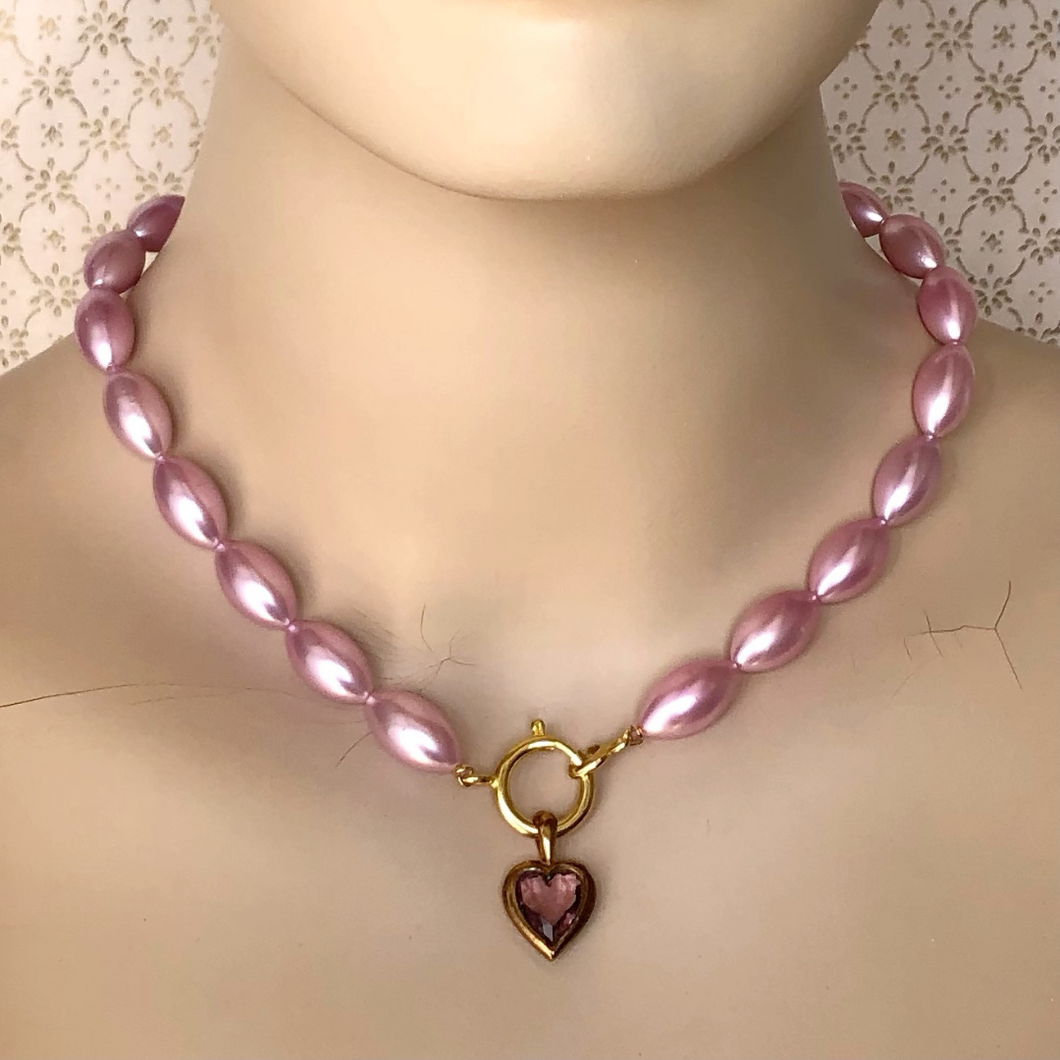 necklace of vintage rice-shaped pearlised beads in soft amethyst pink with vintage amethyst heart pendant displayed on a mannequin
