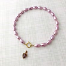 Load image into Gallery viewer, necklace of vintage rice-shaped pearlised beads in soft amethyst pink with vintage amethyst heart pendant removed from spring lasp
