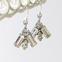 Load image into Gallery viewer, a pair of rhinestone earrings hanging from a white wire frame
