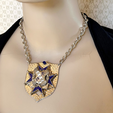 Load image into Gallery viewer, Mannequin wearing a decorative necklace with a shield-shaped pendant
