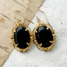 Load image into Gallery viewer, black glass earrings in gold toned frames against vintage paper background
