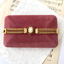 Load image into Gallery viewer, double strand chain bracelet with cameo focal displayed on a vintage velvet jewellery box
