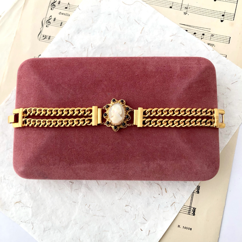 double strand chain bracelet with cameo focal displayed on a vintage velvet jewellery box
