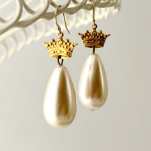 Load image into Gallery viewer, Pearl drop earrings with crown embellishments on a neutral background
