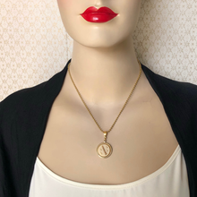 Load image into Gallery viewer, Mannequin wearing a gold necklace with a music pendant against a textured beige background

