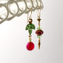 Load image into Gallery viewer, asymmetric earrings in pink and green hanging from a white frame
