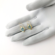 Load image into Gallery viewer, earrings made with Swarovski channel-set aqua rhinestones in a heart shape displayed on a gloved hand
