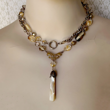Load image into Gallery viewer, long bead and chain necklace in caramel colours with mother-of-pearl pendant wrapped twice around the mannequin's neck
